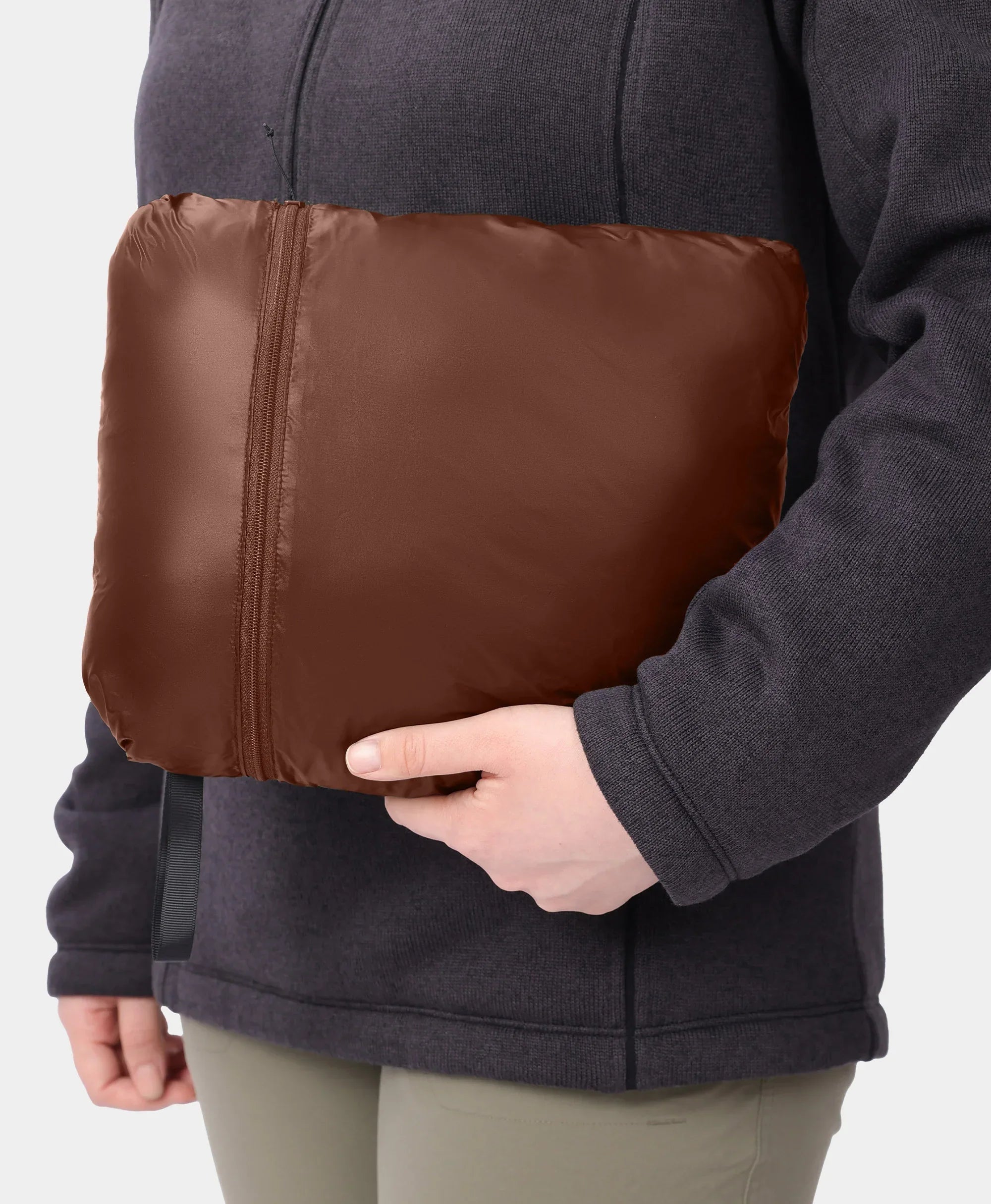 Jacket packs into itself via a large inner pocket and zipper closure